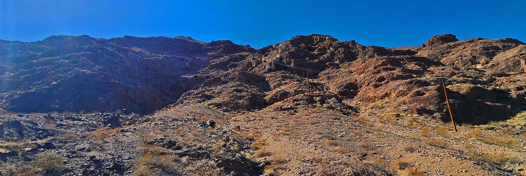 black-canyon-overlook-loop-nevada-02-06-2025-36 View Up Powerlines to Where They Top Cliffs at Peak 2420 | Black Canyon Overlook Loop | Lake Mead NRA, Nevada