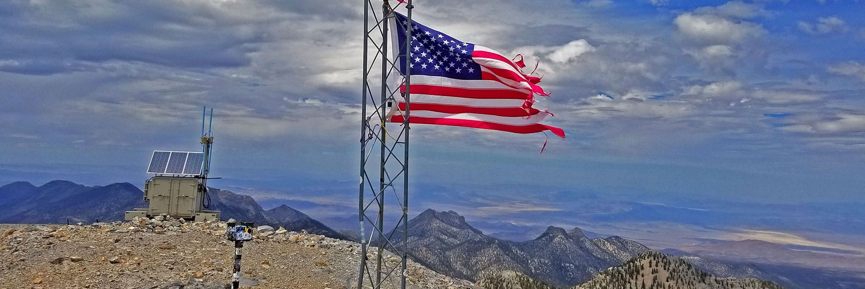 Flag Flies in High Winds on Charleston Peak Summit. Lee Peak and Sisters Peaks Below. | Lee and Charleston Peaks via Lee Canyon Mid Ridge | Mt Charleston Wilderness | Spring Mountains, Nevada
