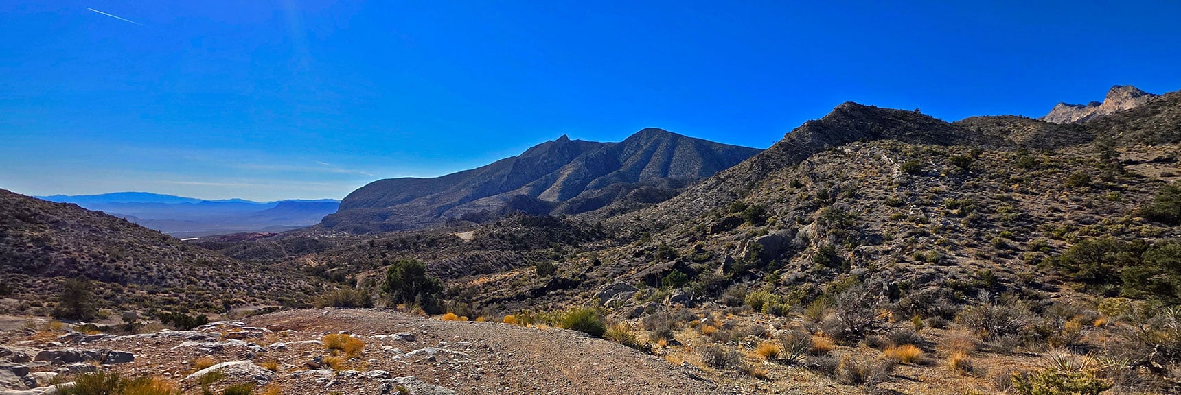 Crossing Over SE Pass. Damsel Peak in View. Tip of South Cliffs Far Right. | La Madre Ridge East Base Circuit | La Madre Mountains Wilderness, Nevada