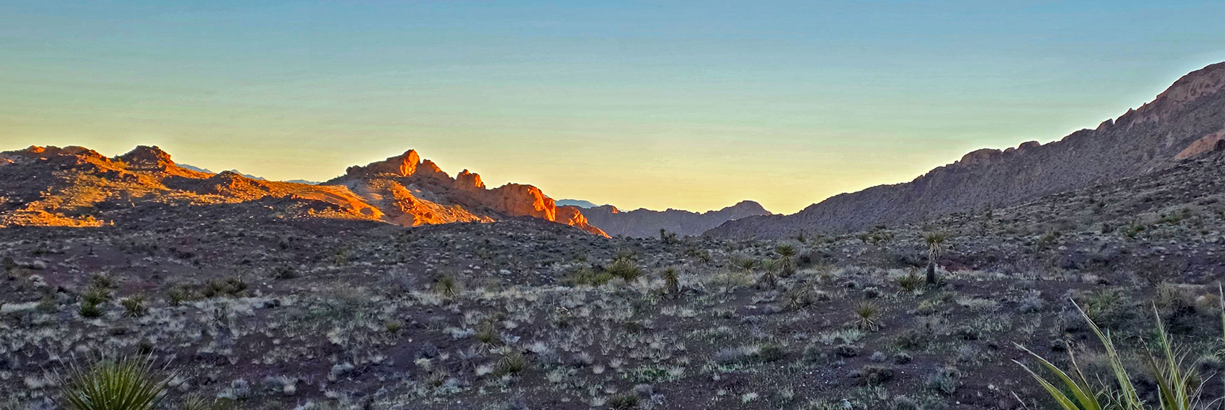 Entrance of West Canyon is to Right of Sandstone Formation in Sun. | Lonesome Peak West Canyon Loop | Eldorado Wilderness, Nevada