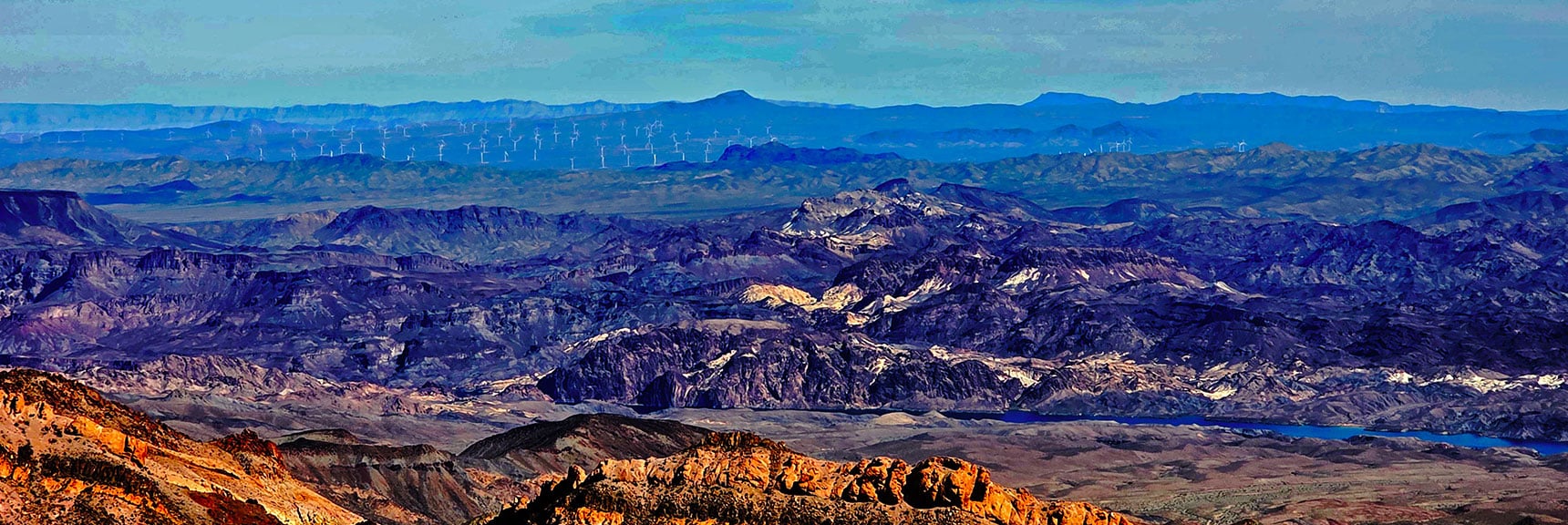 Lonesome Wash Cove on Colorado River at Cliff Base, AZ Wind Farm Beyond. | Nelson Benchmark | Eldorado Wilderness, Nevada