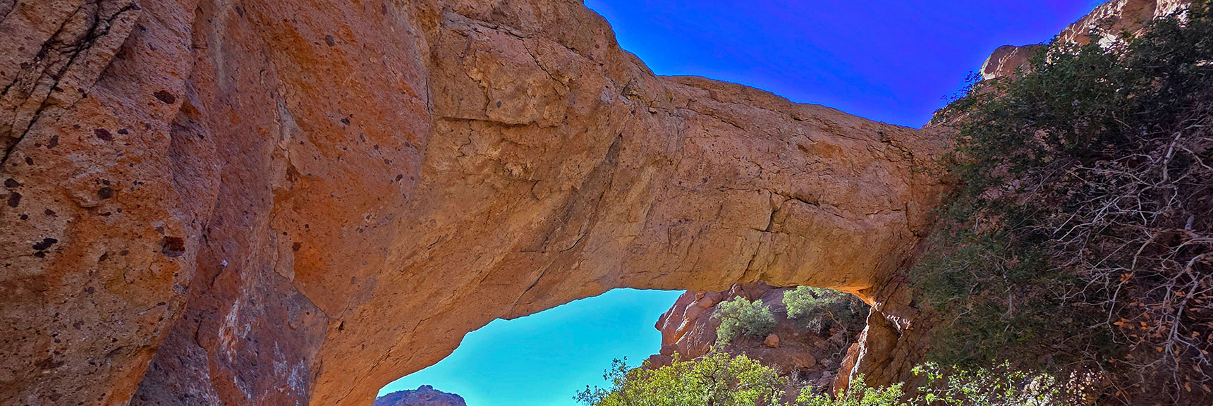 Visit this impressive natural bridge over Bridge Creek in Techatticup Wash. It's only a mile from Hwy 165 in Nevada's Eldorado Wilderness. | Murl Emery Arch | Eldorado Wilderness, Nevada