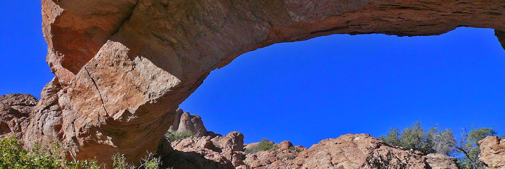 Visit this impressive natural bridge over Bridge Creek in Techatticup Wash. It's only a mile from Hwy 165 in Nevada's Eldorado Wilderness. | Murl Emery Arch | Eldorado Wilderness, Nevada