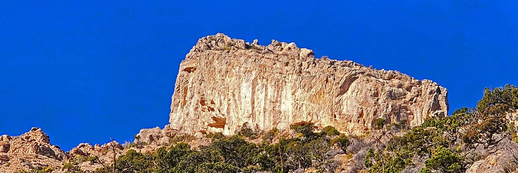 Ascend the massive SE canyon and ridgeline of Damsel Peak to a spectacular limestone formation seen from most points throughout the Las Vegas Valley below. | Damsel Peak Southeastern Pinnacle Loop | La Madre Mountains Wilderness, Nevada